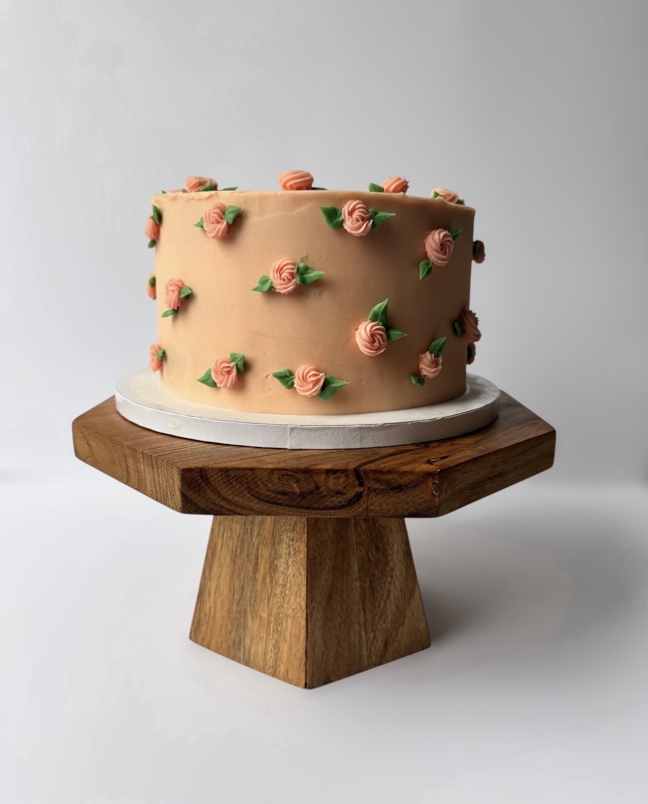 Peach buttercream cake with piped roses